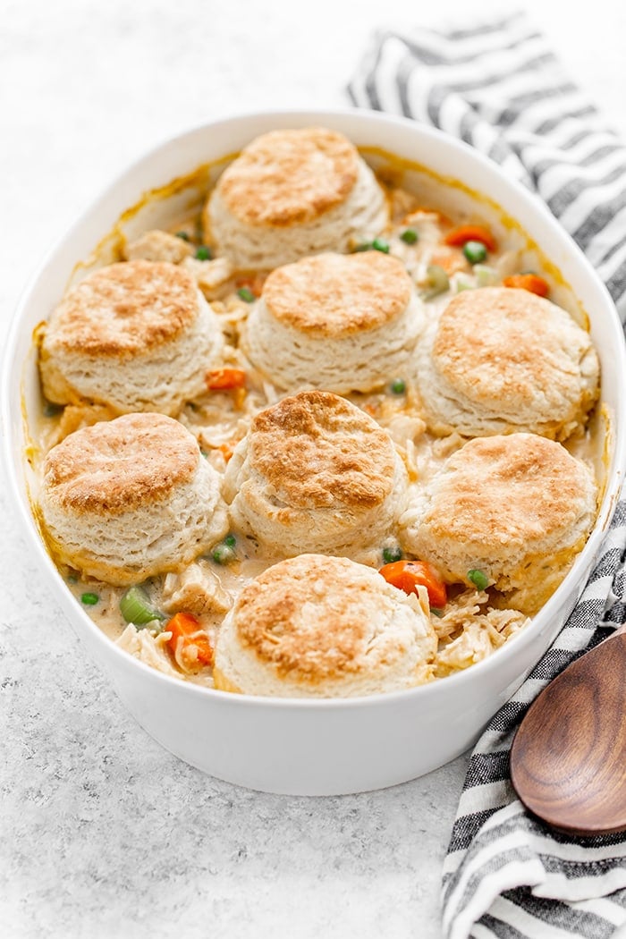 white casserole dish with chicken pot pie with biscuits