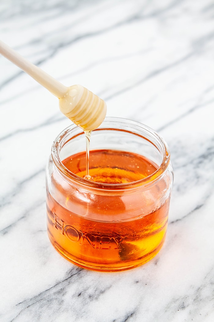 jar of honey on white background