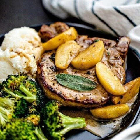 pork chops on a plate with mashed potatoes and broccoli
