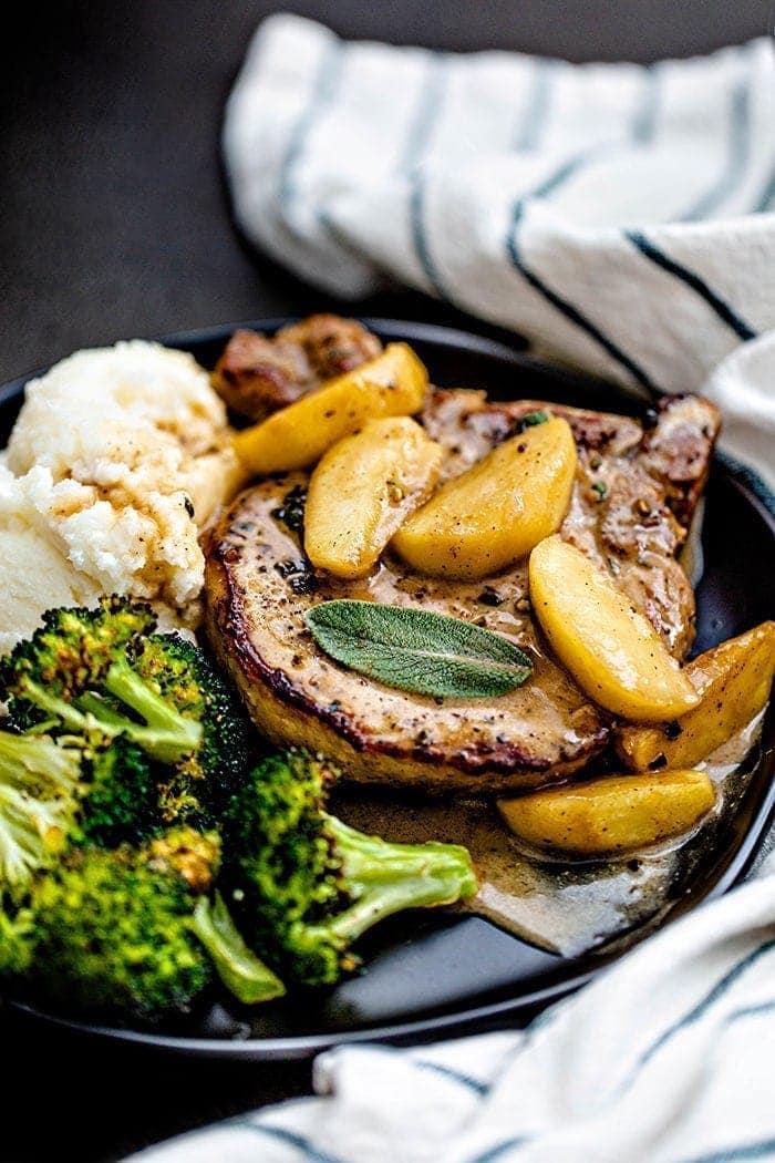 pork chops on a plate with mashed potatoes and broccoli