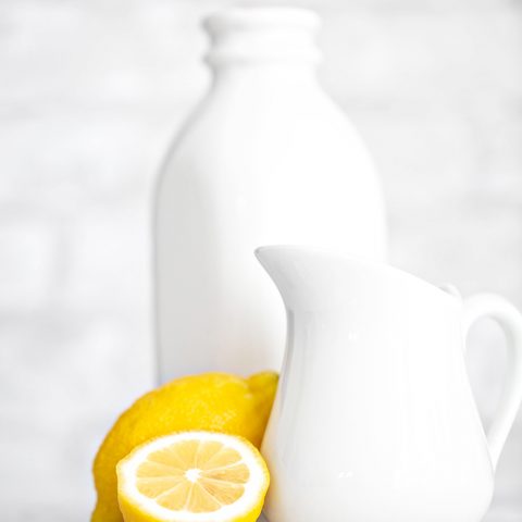 a photo of lemon and pitcher of milk to make a buttermilk substitute