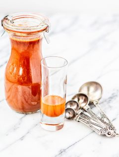container of cough syrup on white background