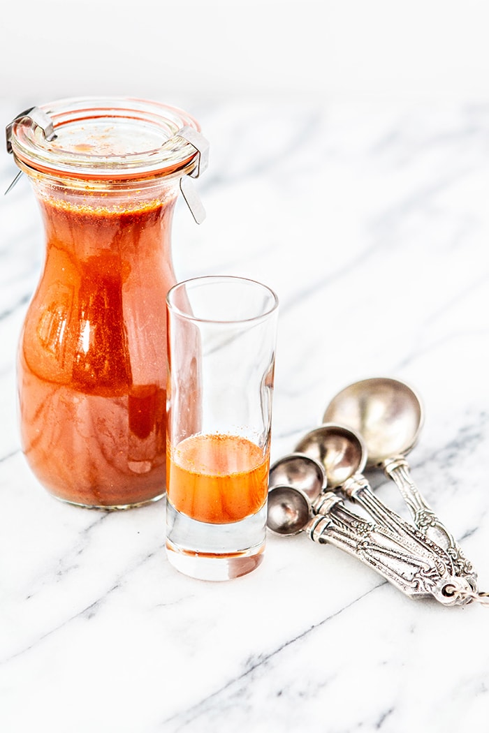 container of cough syrup on white background