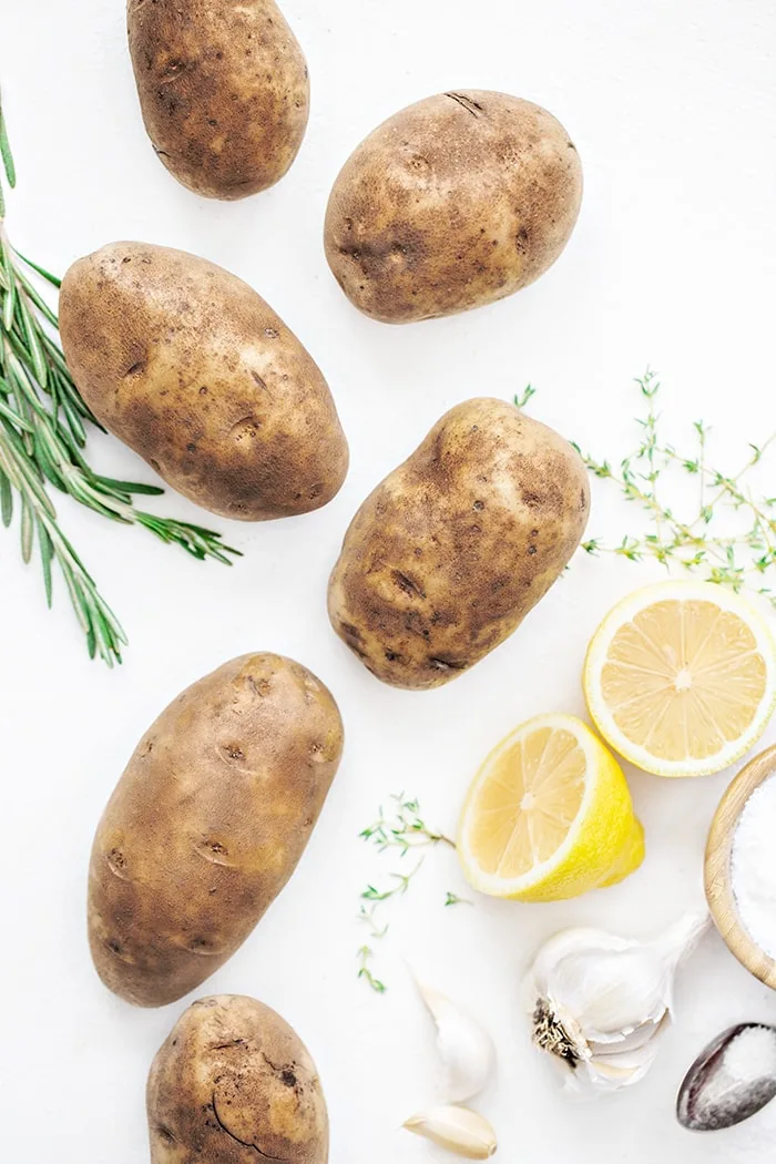 potatoes and rosemary on a white background