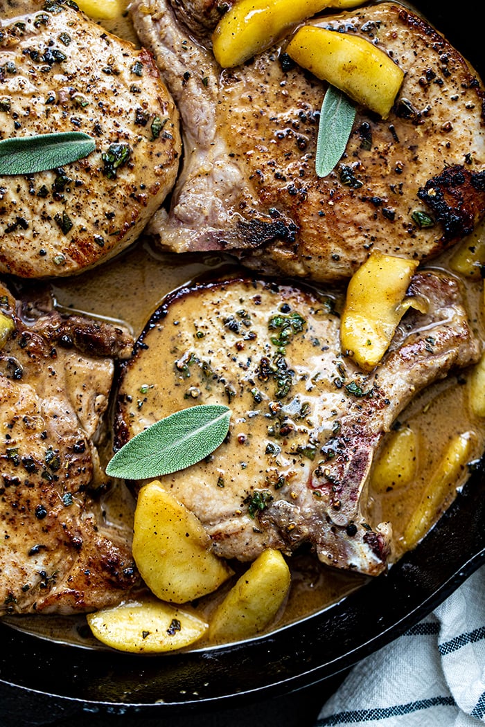 close up overhead photo of Apple Cider Pork Chops in a cast iron skillet