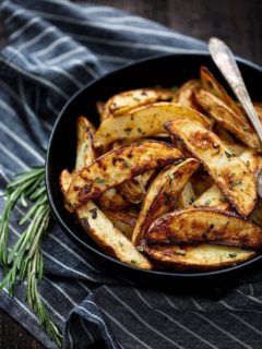 roasted potatoes in bowl with rosemary