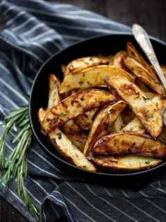 roasted potatoes in bowl with rosemary
