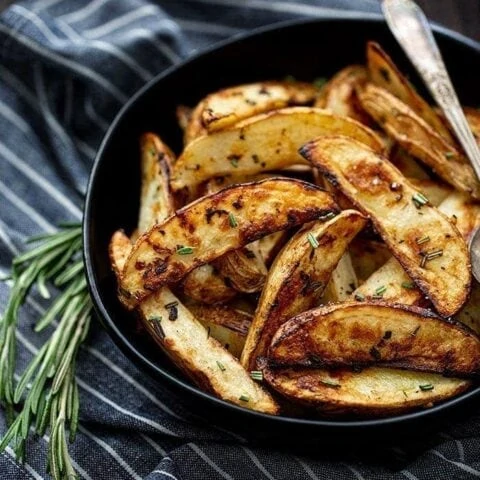 roasted potatoes in bowl with rosemary