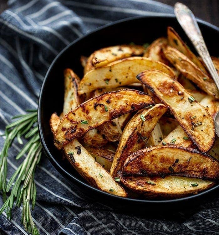 roasted potatoes in bowl with rosemary