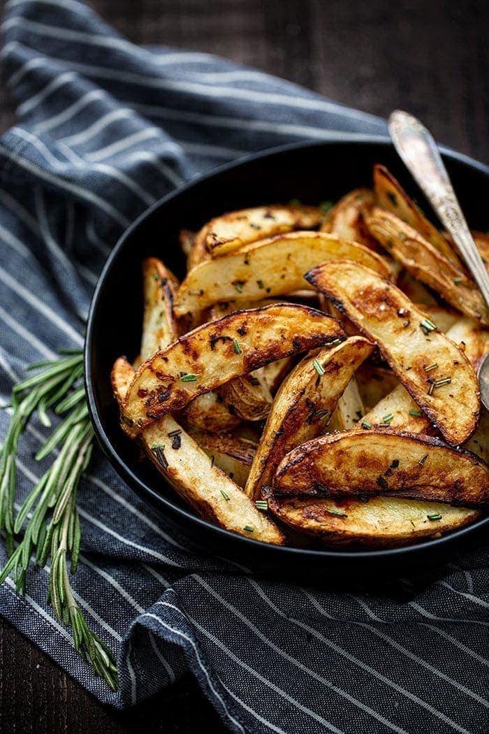 roasted potatoes in bowl with rosemary