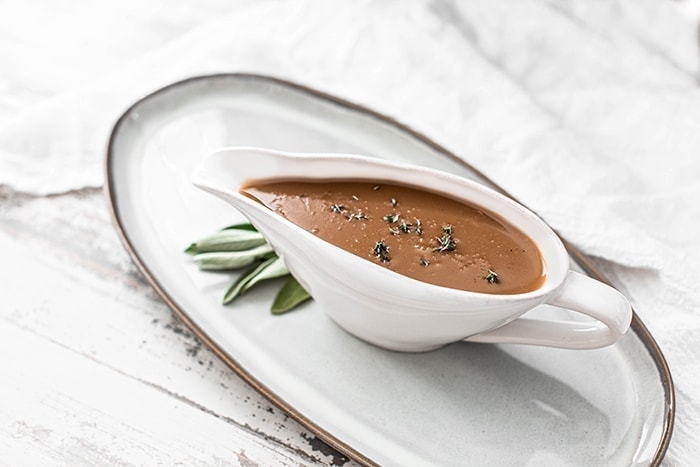 homemade turkey gravy in a white gravy boat