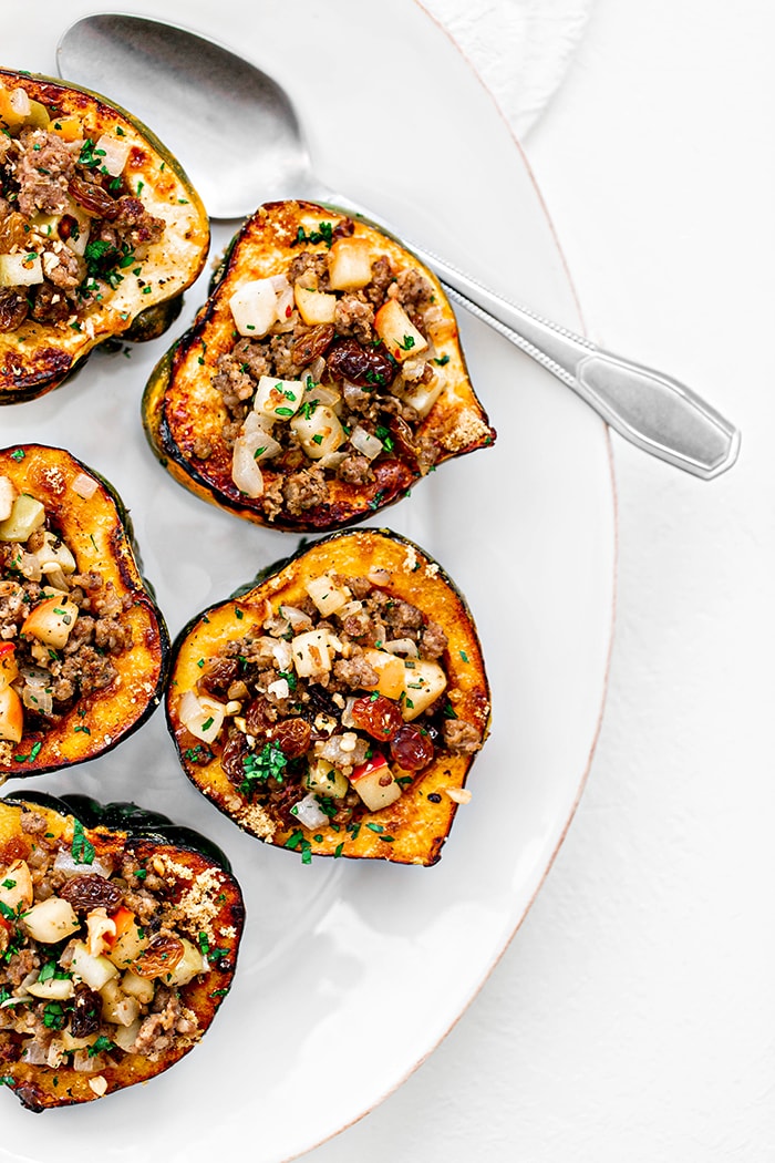 apple stuffed acorn squash on white plate