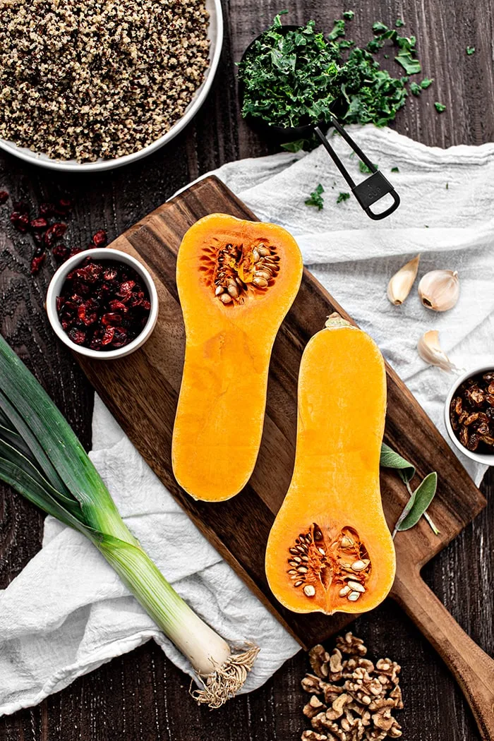 photo of ingredients (butternut squash, dried cranberries, leeks, walnuts, quinoa, garlic) to make this quinoa stuffing (recipe for butternut squash stuffing with quinoa)