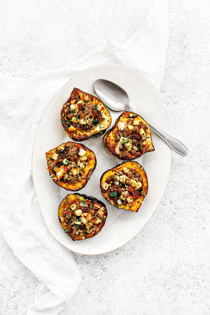 white platter with vegetarian stuffed acorn squash