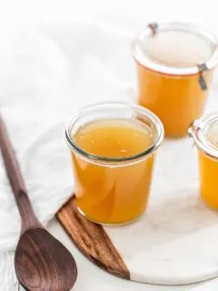 jars of turkey stock on a white background