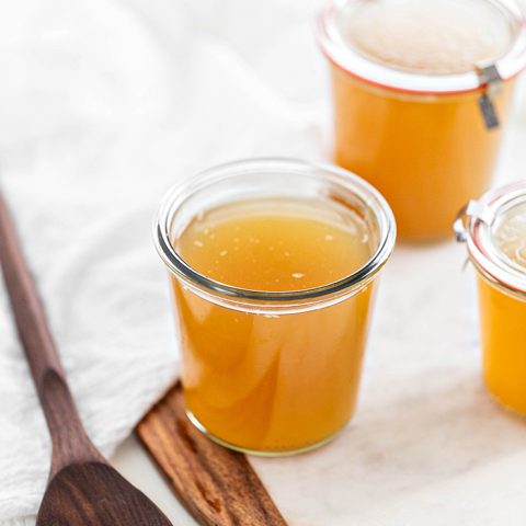 jars of turkey stock on a white background