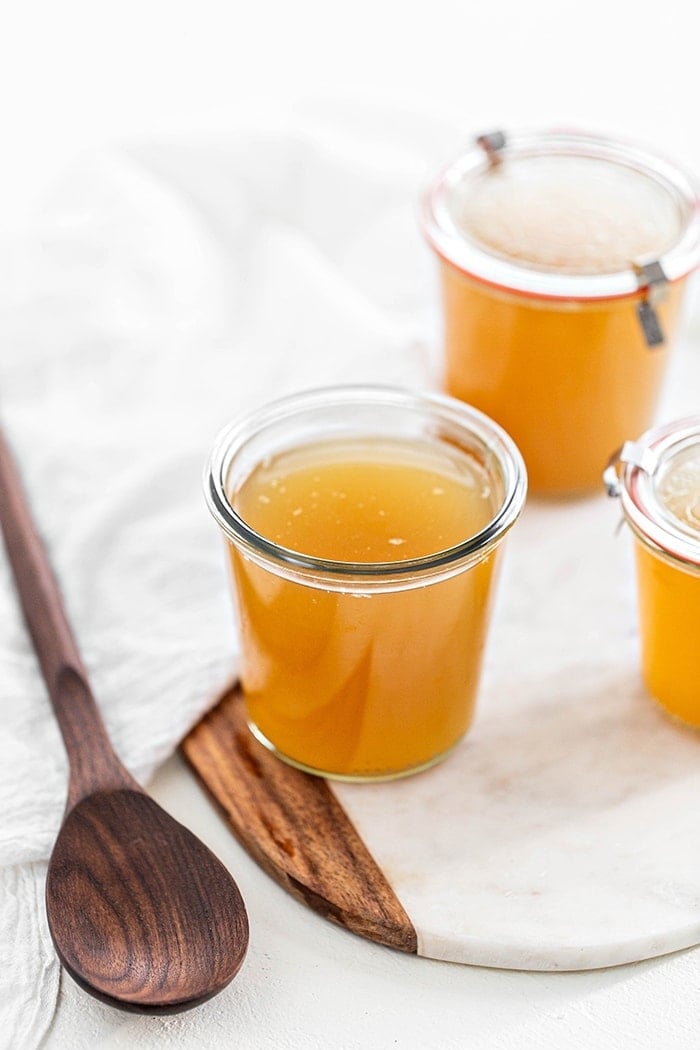 jars of turkey stock on a white background