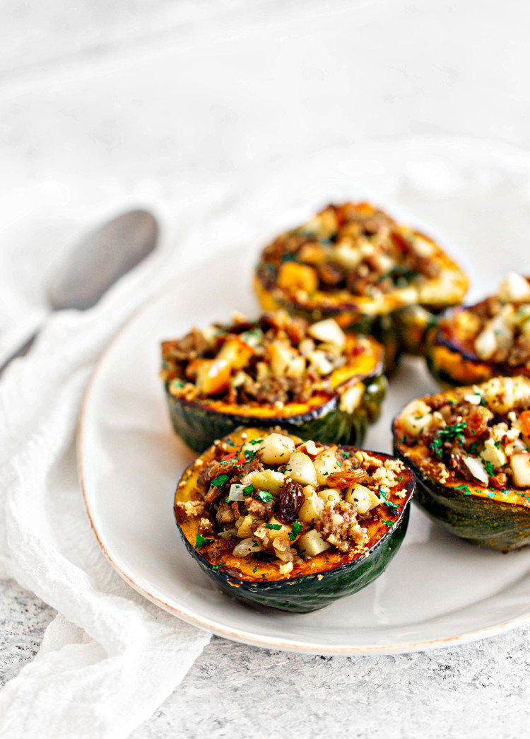 white platter with sausage and apple stuffed acorn squash