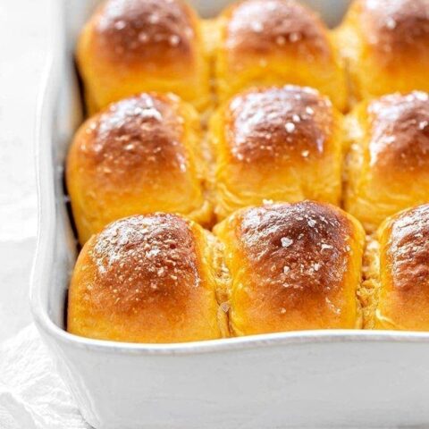 sweet potato dinner rolls in a white baking dish