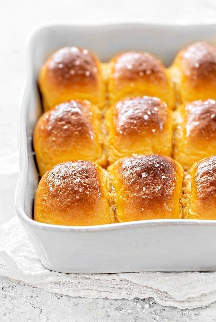 sweet potato dinner rolls in a white baking dish