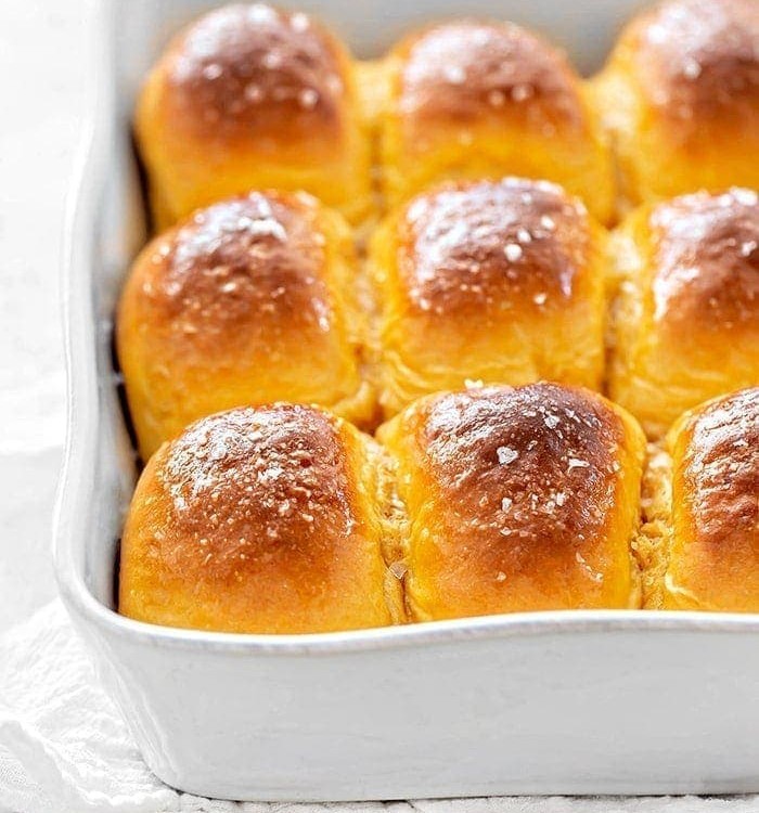 sweet potato dinner rolls in a white baking dish