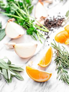 orange slices and fresh herbs on white background