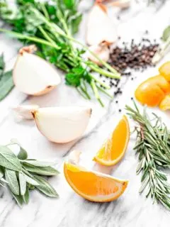 orange slices and fresh herbs on white background