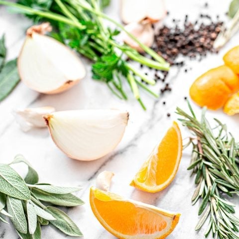 orange slices and fresh herbs on white background