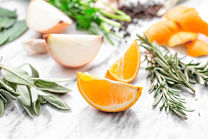 photo of oranges and fresh herbs on white background