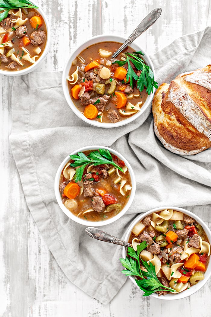 3 bowls of soup on a white table