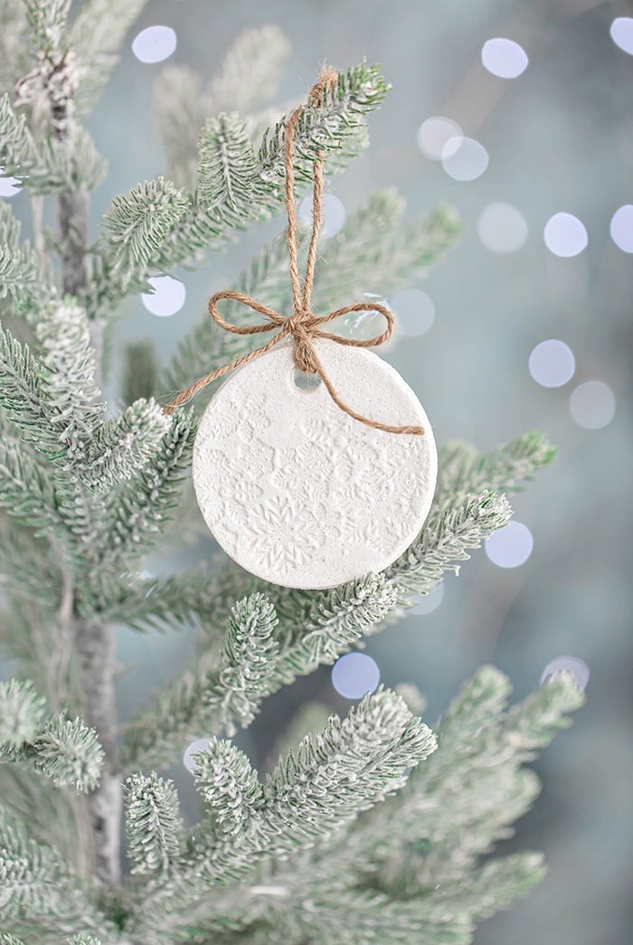 salt dough ornament on a christmas tree with lights