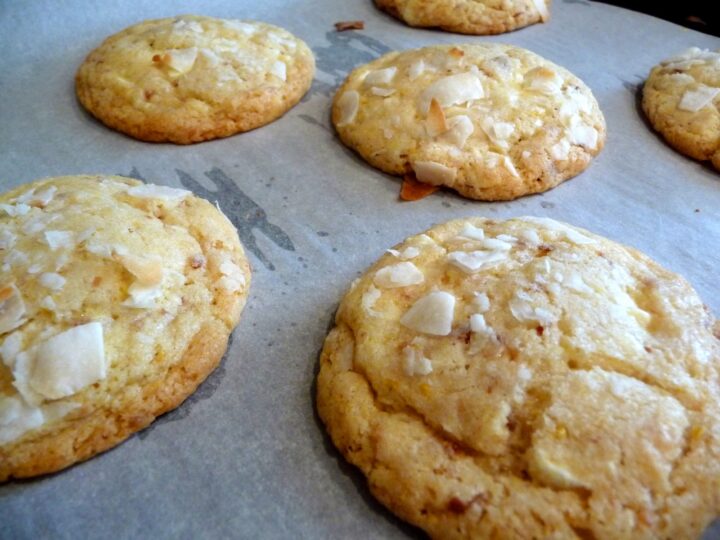 photo of lemon white chocolate cookies on a parchment paper covered baking sheet