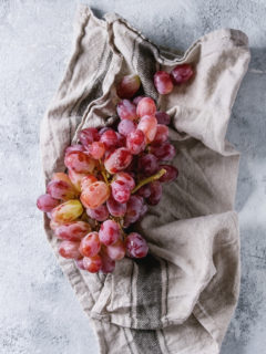 washed red grapes on a towel
