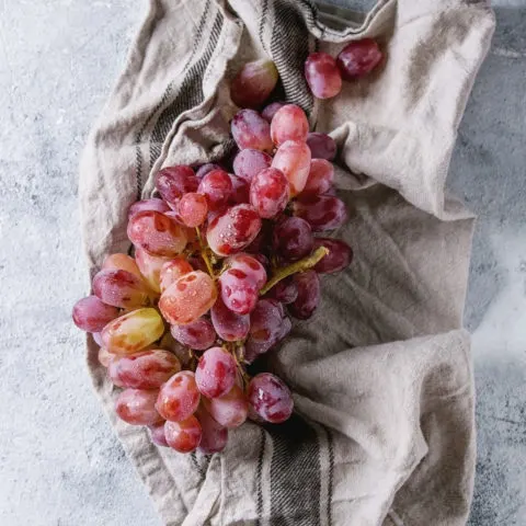 washed red grapes on a towel
