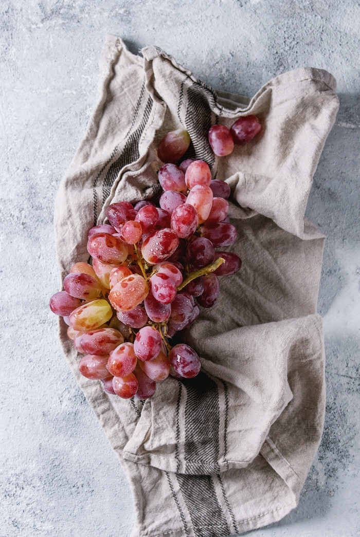 washed red grapes on a towel