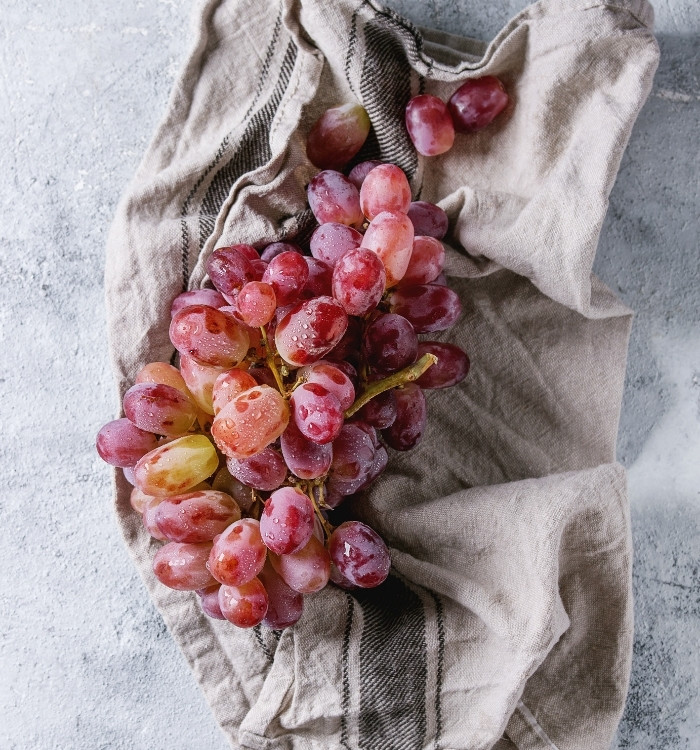 washed red grapes on a towel