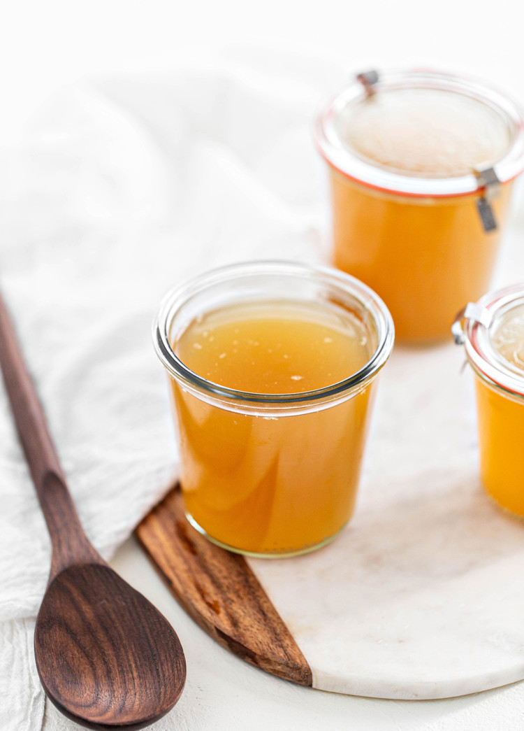 jars of turkey stock on a white background