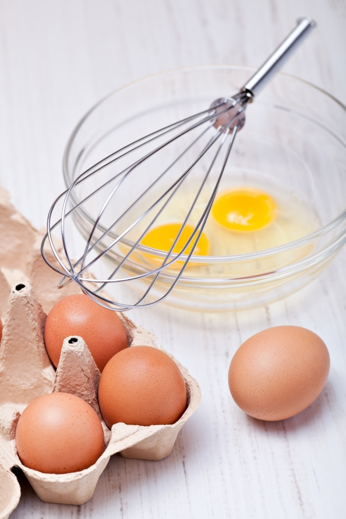 cracked eggs in a bowl with whisk for instructions about how to freeze eggs
