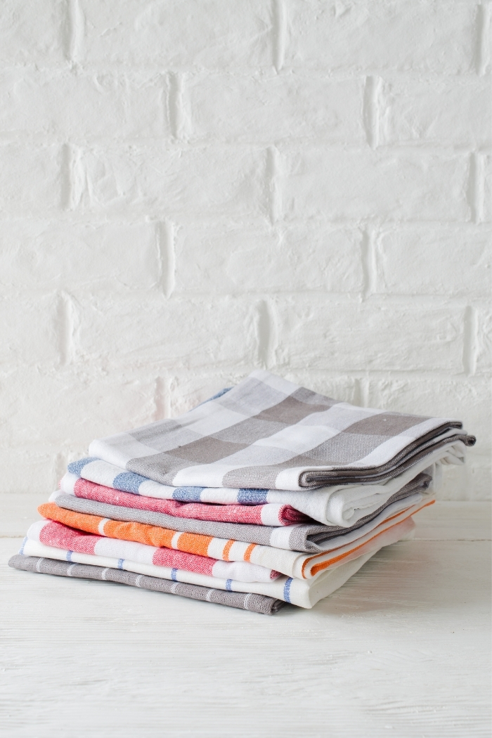 a stack of folded dish towels on a white background