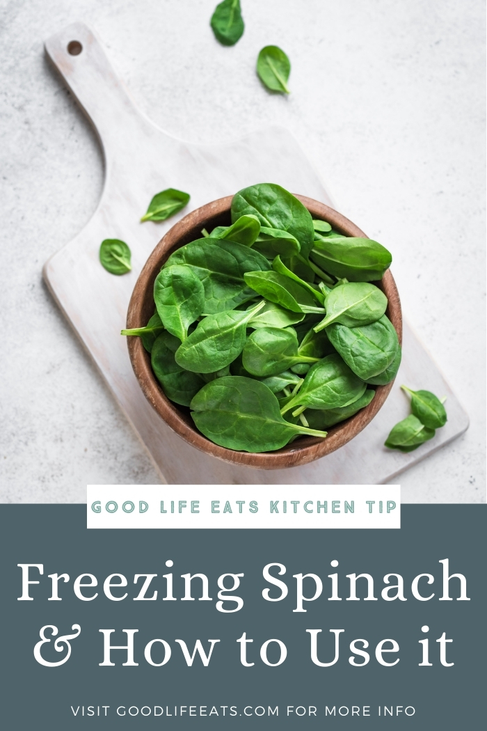 bowl of spinach leaves on a cutting board