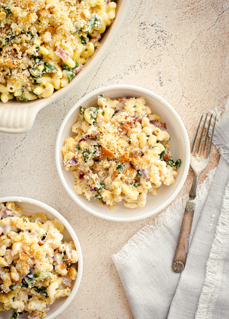 overhead photo of bowl of white cheddar mac and cheese next to a fork and napkin