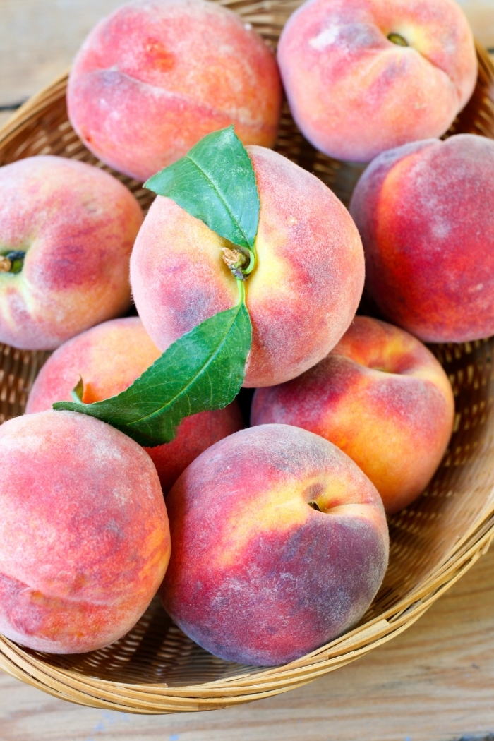 wooden basket of fresh peaches