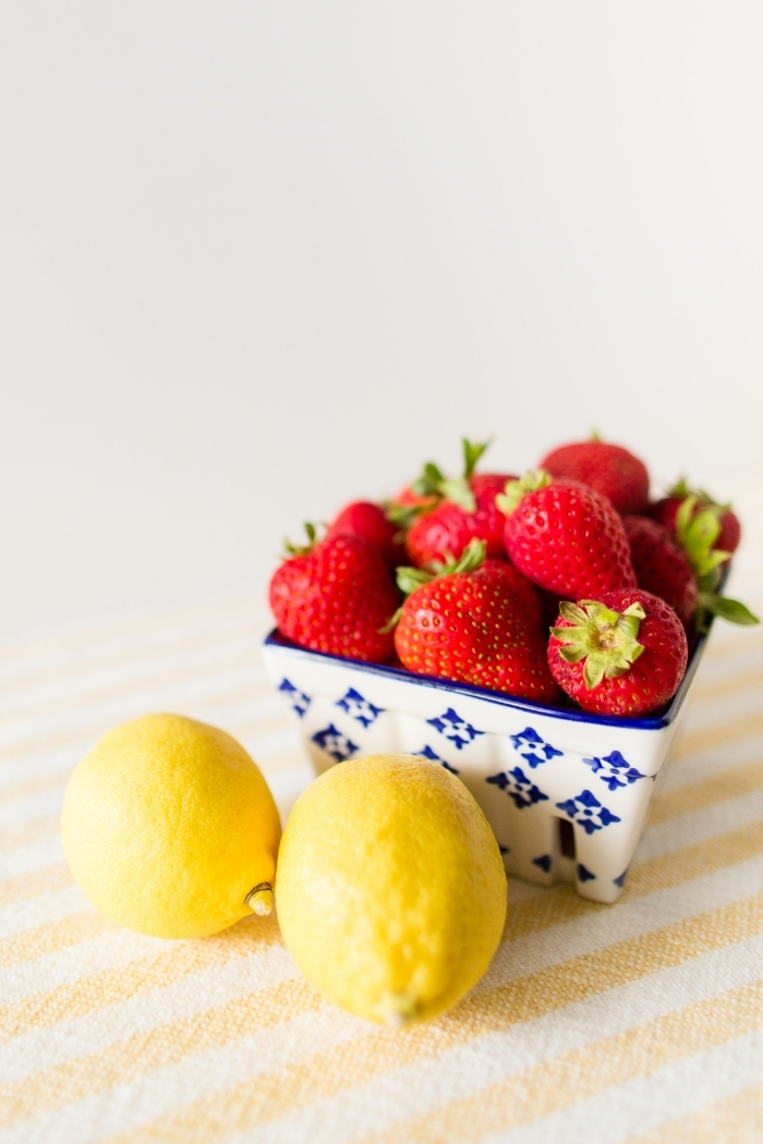 strawberries and lemons on a counter