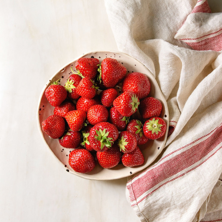 fresh strawberries preparing to be frozen