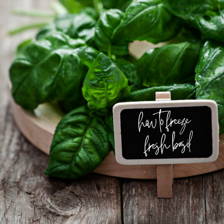 fresh basil on a wooden cutting board