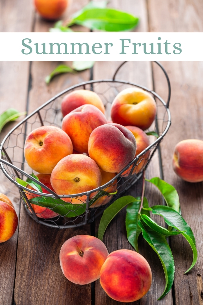 freshly picked peaches in a basket on a wooden table