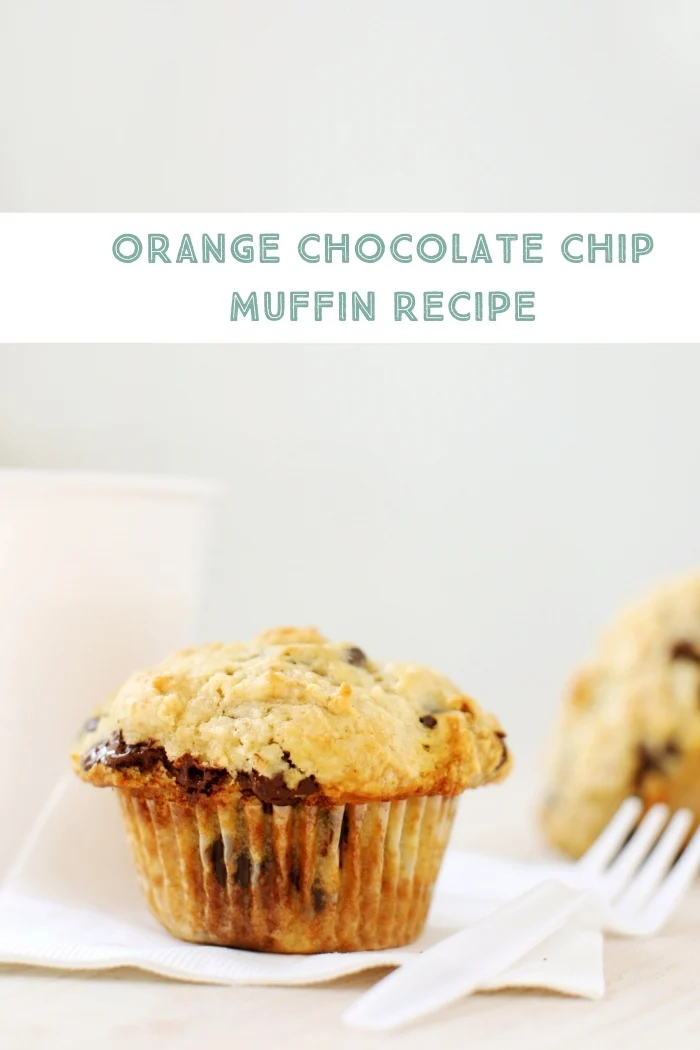 orange chocolate chip muffin on a napkin with a fork
