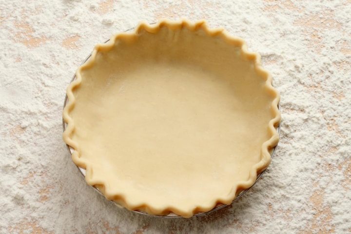overhead shot of an unbaked pie dough in a pan using this all butter pie crust recipe