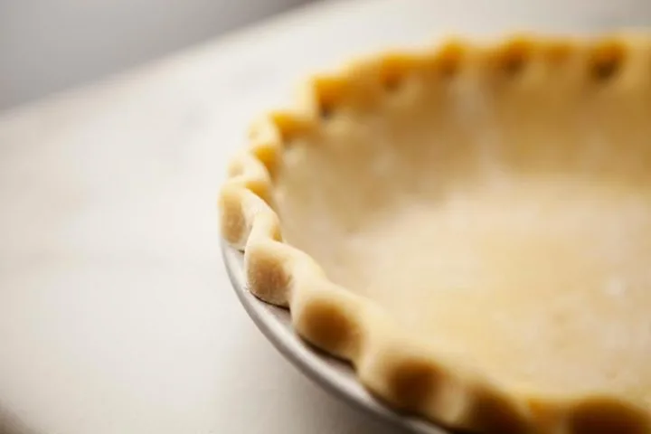 close up of edging on an unbaked all butter pie crust