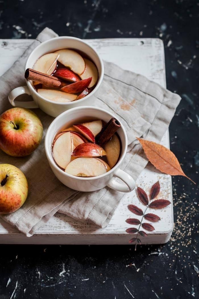 mugs of wassail on a cutting board